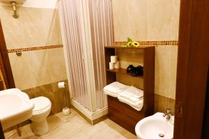a bathroom with a shower and a toilet and a sink at Sunrise B&B in Naples +70 photos