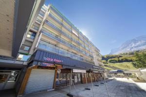 a building with a sign on the front of it at Ô Cocon - Station de ski à pied vue montagne in Eaux-Bonnes