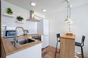 a kitchen with a sink and a counter at Hauzify I Apartament Hortènsia in Platja  d'Aro +8 photos