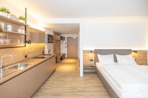 Posteľ alebo postele v izbe v ubytovaní ALPRIMA Aparthotel Hinterstoder