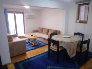 a living room with a table and a couch at Vila Afan Ušivak in Sarajevo