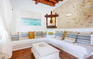 a living room with a white couch and a table at Villa Sada in Santa Eularia des Riu +18 photos
