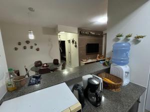 a kitchen with a counter top with a counter top at Apartamento na praia de Bombas Edifício Umuarama nº 63, bloco B in Bombinhas
