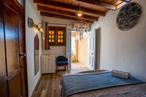 a bedroom with a bed and a chair in a room at Dream Catcher in Dahab