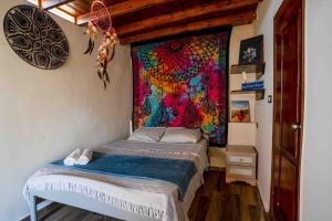 a bed in a room with a painting on the wall at Dream Catcher in Dahab +19 photos