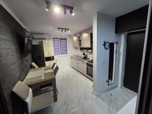 a large kitchen with a table and chairs in it at AIM & Residence in Piteşti