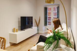 Una televisión o centro de entretenimiento en Bravissimo Apartaments Mora 4