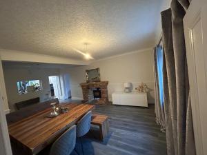 a living room with a wooden table and a fireplace at The PADhouse in York