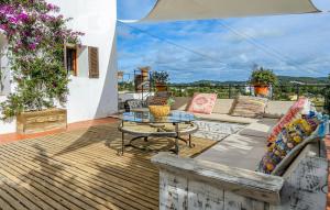 a patio with a table and a couch on a deck at Villa Pranayama in Santa Gertrudis de Fruitera
