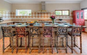 a kitchen with a large wooden table with chairs at Villa Pranayama in Santa Gertrudis de Fruitera +18 photos