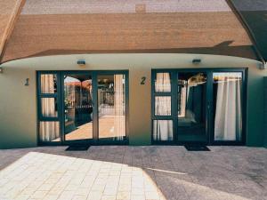 an open door of a house with glass windows at Boutique On Madeliefie in Welkom