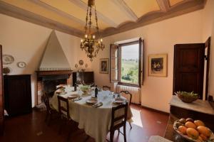 a dining room with a table and a fireplace at Timeless Elegance in Poggibonsi