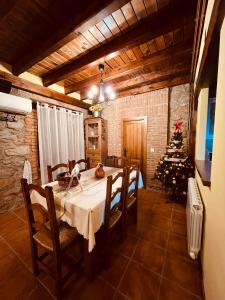 a dining room with a table and a christmas tree at Villa Revolcona in La Adrada +44 photos