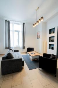 a living room with two couches and a table at New Favoriten - Serviced Apartments in Vienna