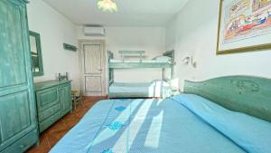 a bedroom with a bed and a bunk bed at Apartments In Golfo Orosei in Orosei