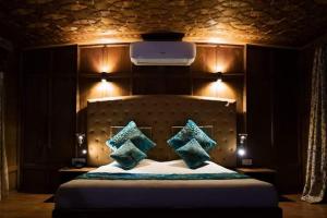 a bedroom with a large bed with four pillows at Goona residence in Srinagar