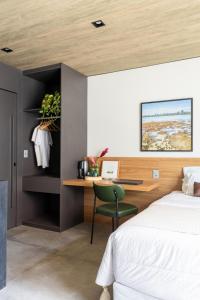 ein Schlafzimmer mit einem Bett und einem Schreibtisch mit Stuhl in der Unterkunft beira-mar pajuçara in Maceió + 22 Fotos