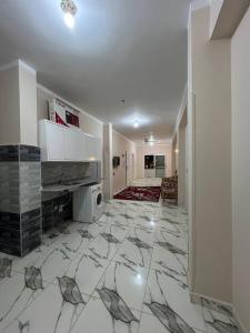 a living room with a tile floor with a fireplace at The Nile flat in Luxor +3 photos