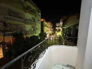 a view of a balcony of a building at night at The Nile flat in Luxor