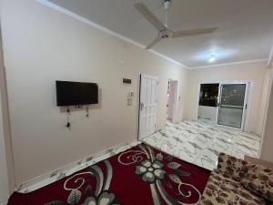 a living room with a flat screen tv on the wall at The Nile flat in Luxor