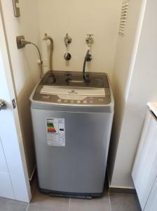 a trash can in a bathroom with a sink at la serena 1 dormitorio in La Serena