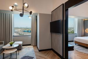 a hotel room with a bed and a large window at Sheraton Mall of the Emirates Hotel, Dubai in Dubai