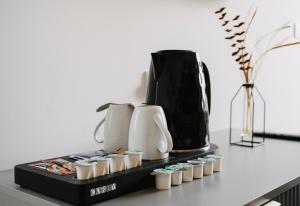 a tray with cups and a coffee maker on a table at WNS Skylines Village in London
