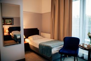 Posteľ alebo postele v izbe v ubytovaní Hotel Kuracyjny Spa & Wellness