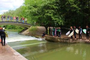a group of people standing on a bridge with surfboards at Løst Souls Oktoberfest Campsite in Munich