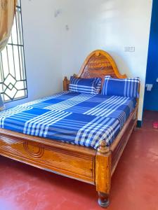 a bed in a room with a blue and white at Ushongo Econostay in Wanga