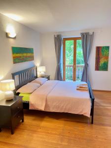 a bedroom with a large bed and a window at Centro Storico di Merano in Merano