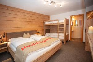 a bedroom with two beds and a bunk bed at Alpenperle in Berwang