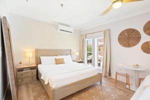Un dormitorio blanco con una cama y una ventana. en Shop House Studio by Stay on 30A- Pool, Bikes, en Rosemary Beach 27 fotos más