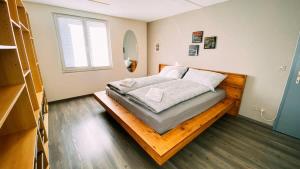 a bedroom with a bed on a wooden platform at Swiss House with Mountain Views in Meiringen