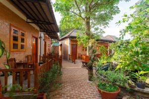 a brick walkway in front of a house with plants at Duy Ngoc Resort Phu Quoc in Phu Quoc