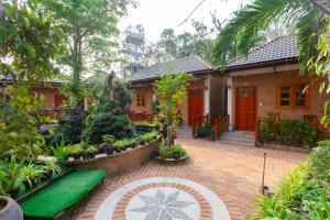 a house with a brick walkway in front of it at Duy Ngoc Resort Phu Quoc in Phu Quoc