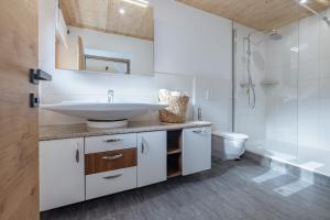 a bathroom with a sink and a shower at Bauernhof Pergila in Maria Luggau +101 photos