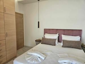 a bedroom with a bed with two towels on it at Our Villa - Villa Rena in Rethymno Town +15 photos