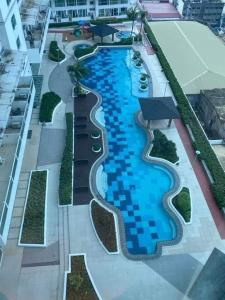 an overhead view of a swimming pool on a building at The Wild Roces Makati, The Beacon Residences in Manila