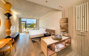 a living room with a bed and a couch at Hotel GLAR Conference & SPA in Wisełka +69 photos
