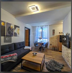 a living room with a couch and a table at D&D Apartman Jahorina in Jahorina