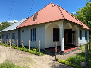 a small house with a red roof at Ushongo Econostay in Wanga