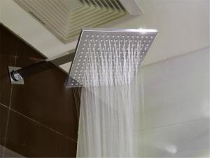a shower with a shower curtain in a bathroom at 7Days Inn Premium Beijing Chaoyangmen in Beijing