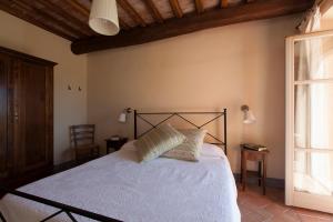 Postel nebo postele na pokoji v ubytování Agriturismo Bio Podere Doganelle