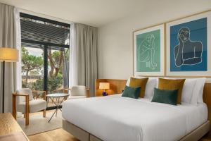 A bed or beds in a room at AC Hotel Gava Mar