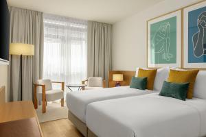 A bed or beds in a room at AC Hotel Gava Mar
