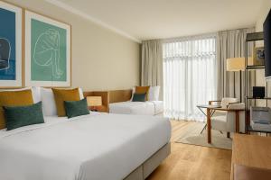 A bed or beds in a room at AC Hotel Gava Mar