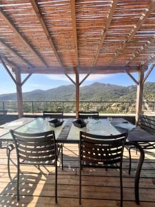 a table and chairs on a deck with a view at Duplex Vista in Bonifacio