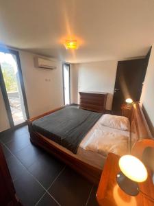 a bedroom with a bed and a table with two lamps at Duplex Vista in Bonifacio