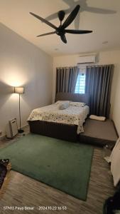 a bedroom with a bed and a ceiling fan at Residensi Gambang Prima UMP in Gambang